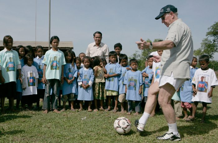 sir-bobby-charlton-and-children-playing-football